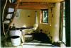 Interior: Barrel stove, heated cob bench, and stabilized earth floor.